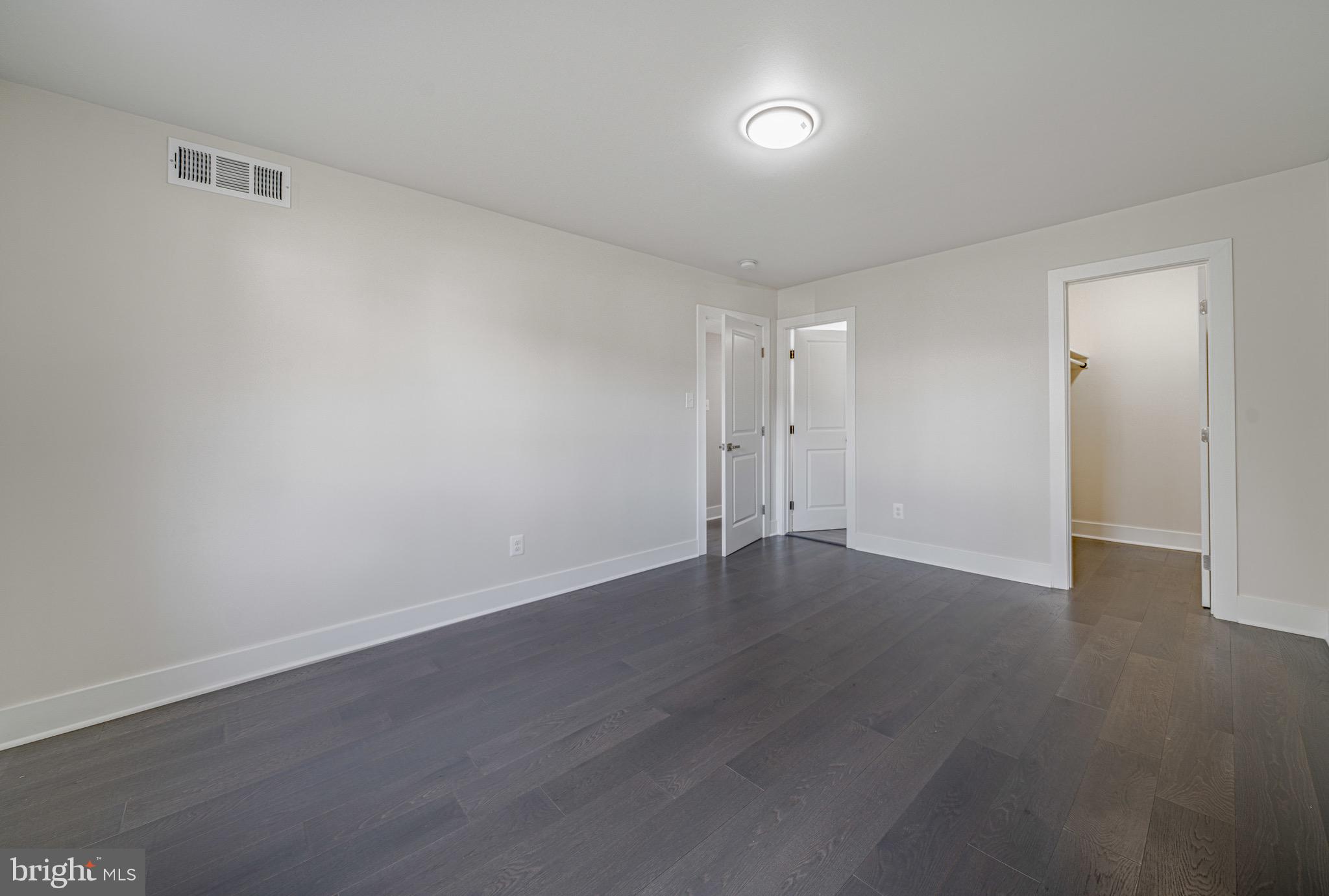 3122 Brinkley Road, Unit 102 Temple Hills, MD 20748 - Photo 29 of 44 a view of an empty room with wooden floor