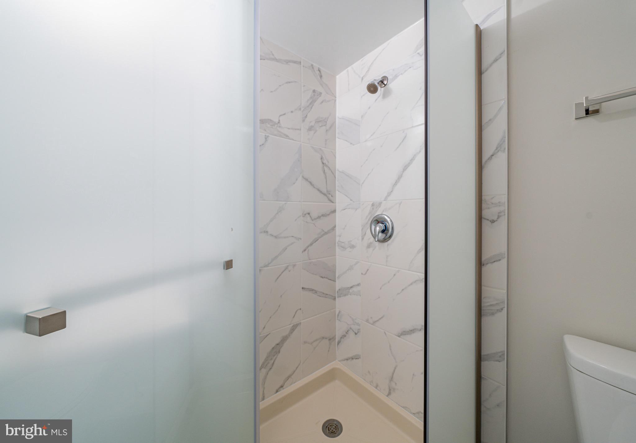 3122 Brinkley Road, Unit 102 Temple Hills, MD 20748 - Photo 32 of 44 a bathroom with a shower