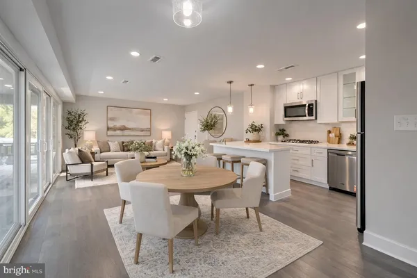 a kitchen with sink a microwave a refrigerator and cabinets