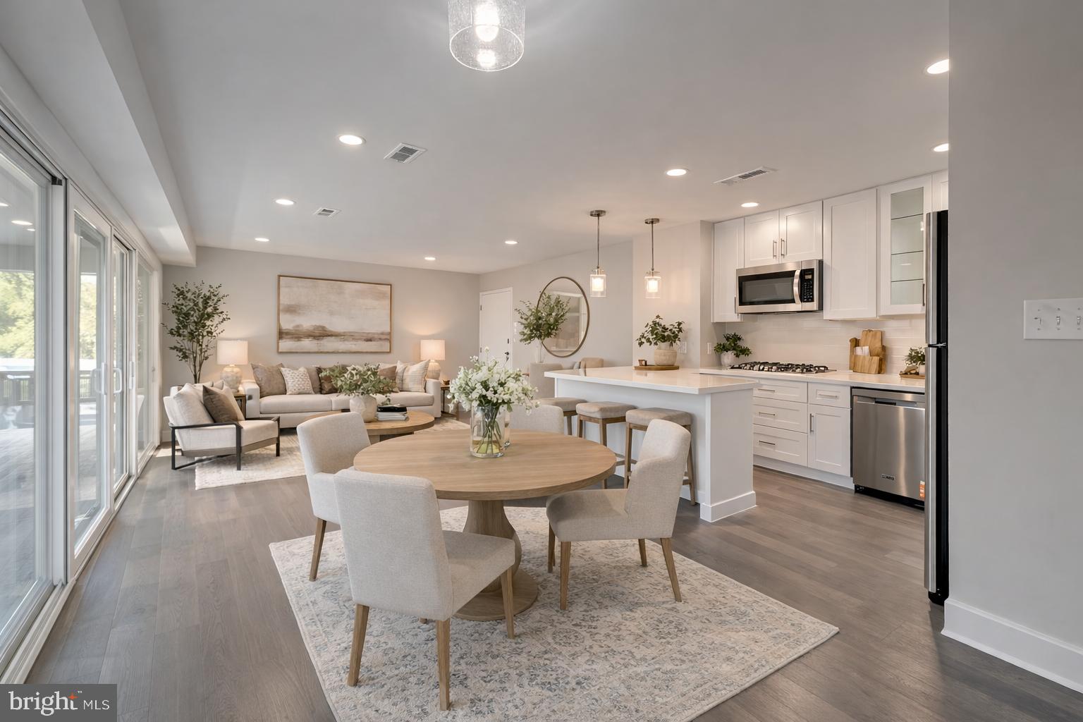3122 Brinkley Road, Unit 102 Temple Hills, MD 20748 - Photo 40 of 44 a living room with stainless steel appliances kitchen island granite countertop furniture and a dining table with kitchen view