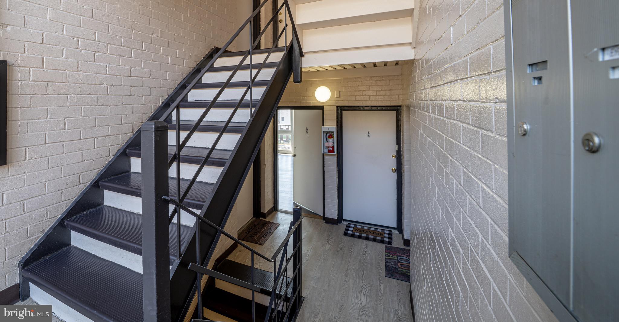 3122 Brinkley Road, Unit 102 Temple Hills, MD 20748 - Photo 5 of 44 a view of staircase with wooden floor and white walls