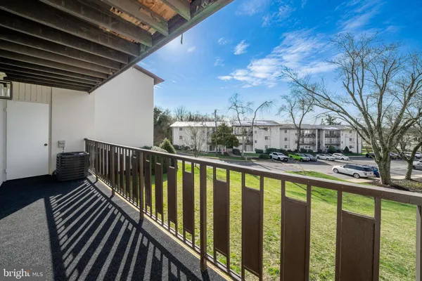 a view of balcony with wooden floor and fence