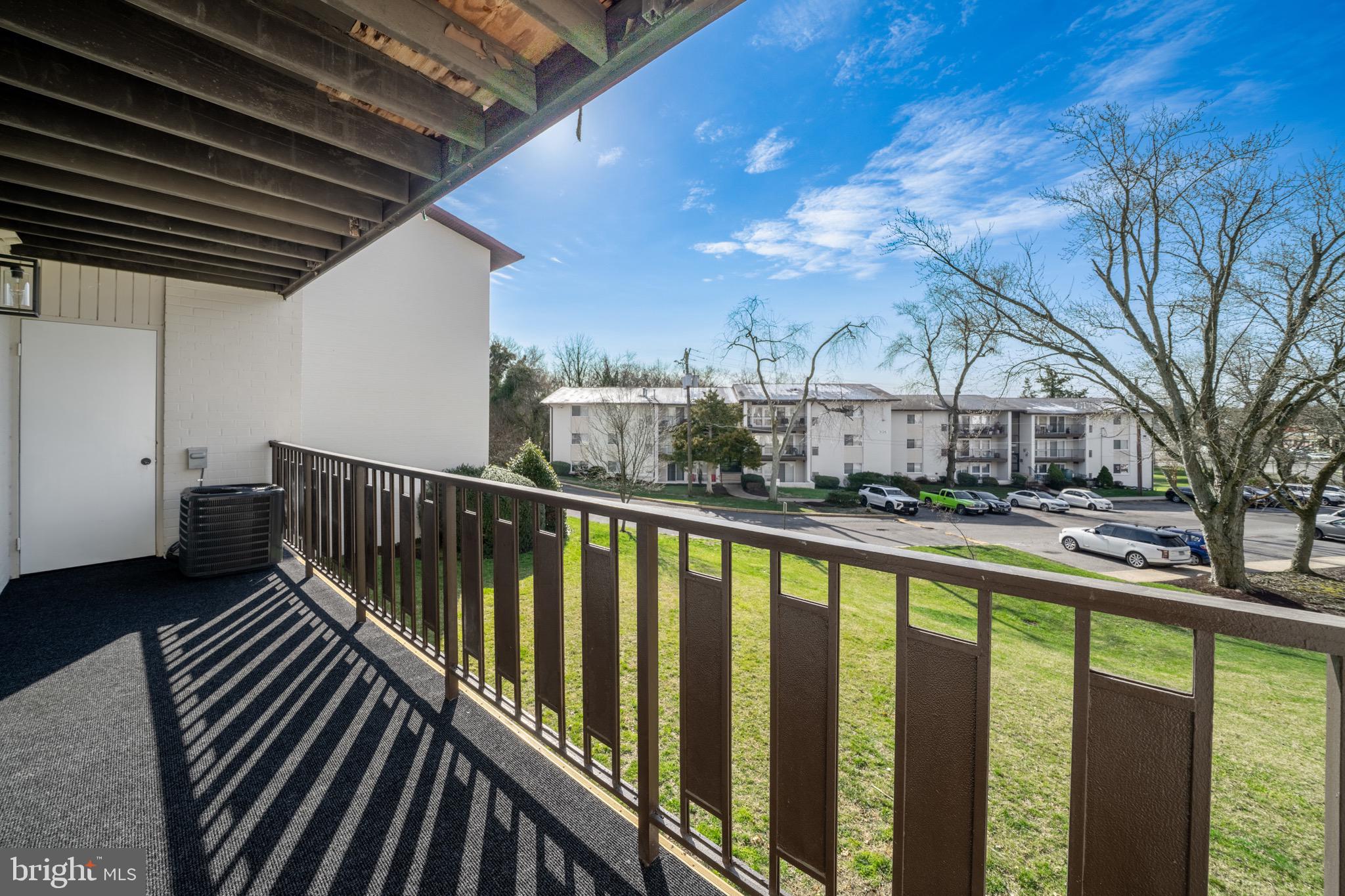 3122 Brinkley Road, Unit 102 Temple Hills, MD 20748 - Photo 9 of 44 a view of balcony with wooden floor and fence