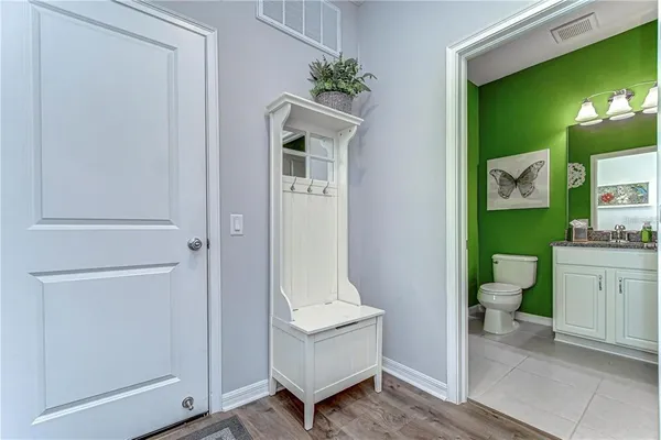a bathroom with a toilet sink and mirror
