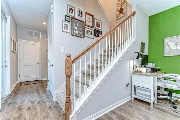 a view of entryway and hall with wooden floor