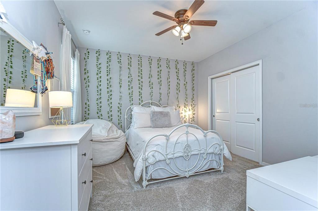5703 Colony Glen Road Lithia, FL 33547 - Photo 35 of 56 a bedroom with a bed and a chandelier