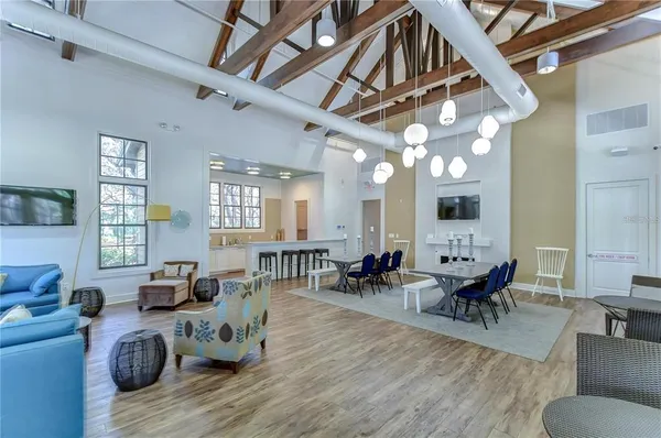 a living room with furniture stove and wooden floor