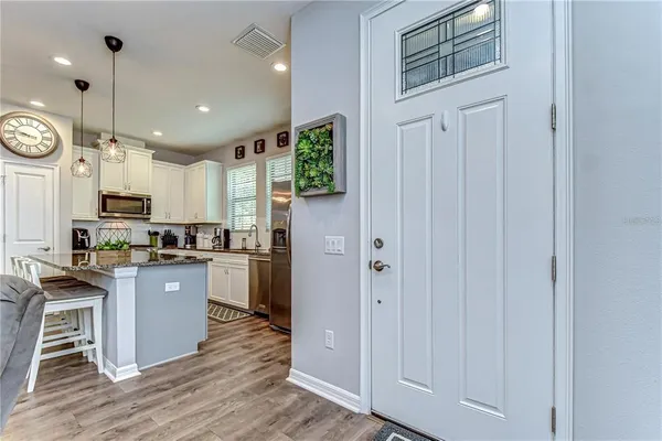 a kitchen with kitchen island granite countertop wooden cabinets and white appliances