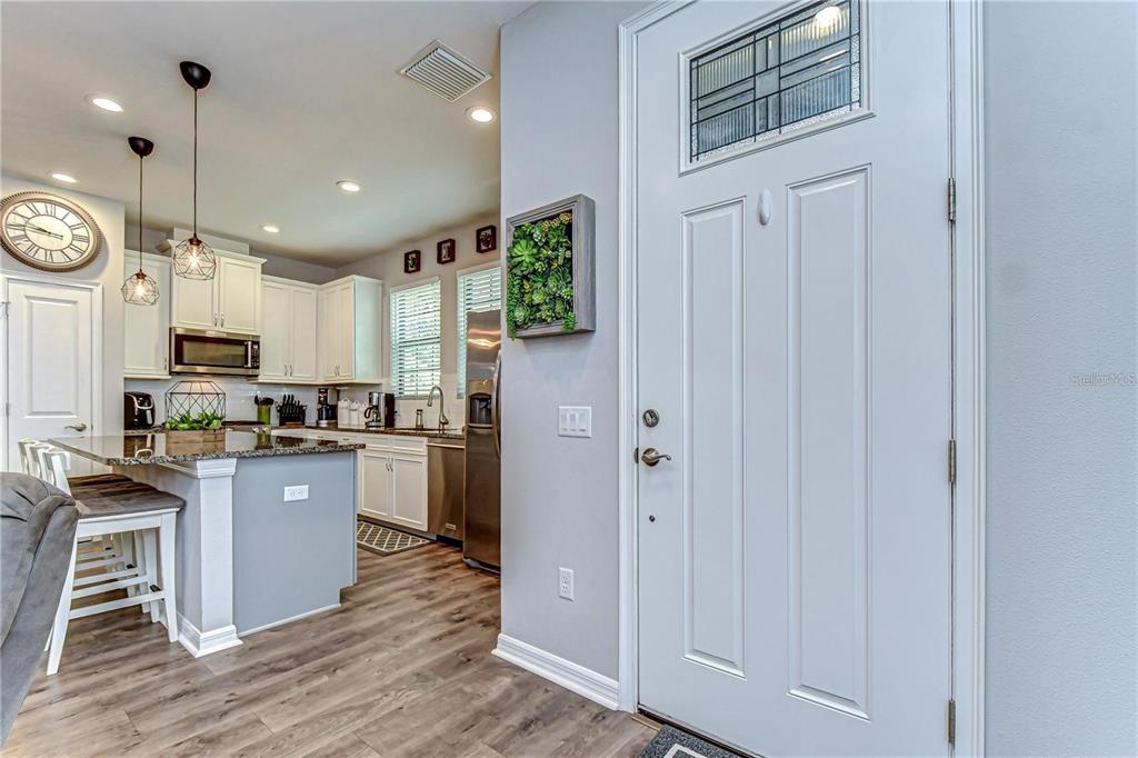 5703 Colony Glen Road Lithia, FL 33547 - Photo 5 of 56 a kitchen with kitchen island granite countertop wooden cabinets and white appliances