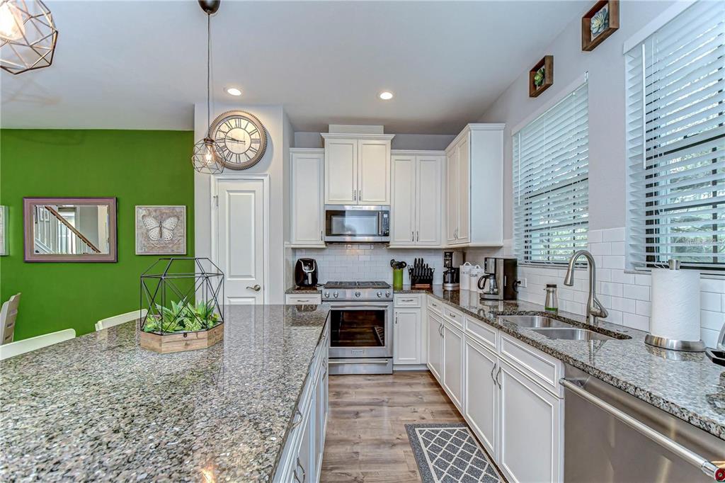 5703 Colony Glen Road Lithia, FL 33547 - Photo 10 of 56 a kitchen with cabinets a window and stainless steel appliances
