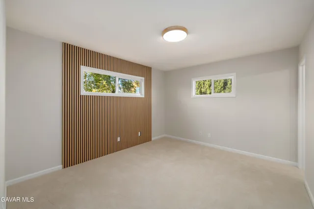 an empty room with windows and wall