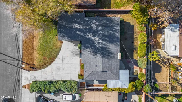 an aerial view of a house with a yard