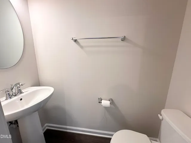 a bathroom with a sink mirror and toilet