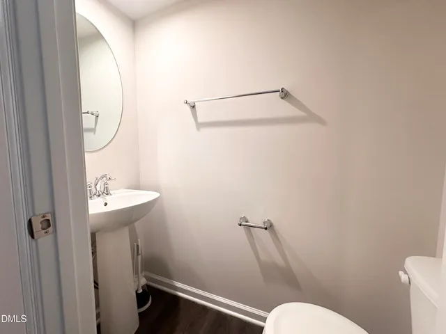 a bathroom with a sink mirror and toilet