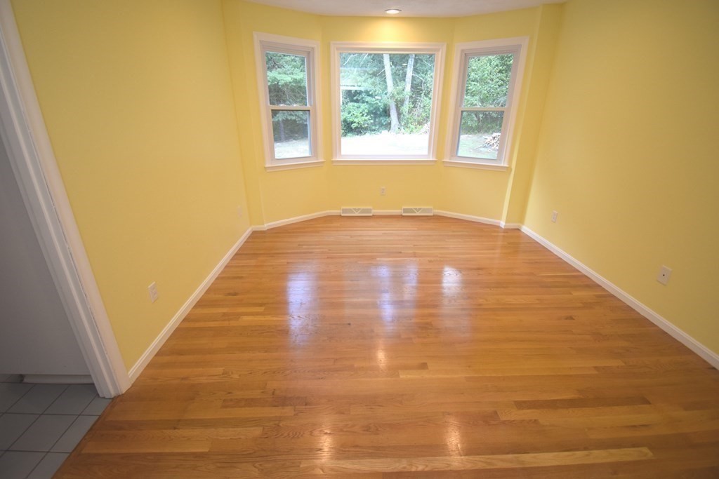 2 Mattakesett Circle Sharon, MA 02067 - Photo 11 of 40 a view of an empty room with wooden floor and a window