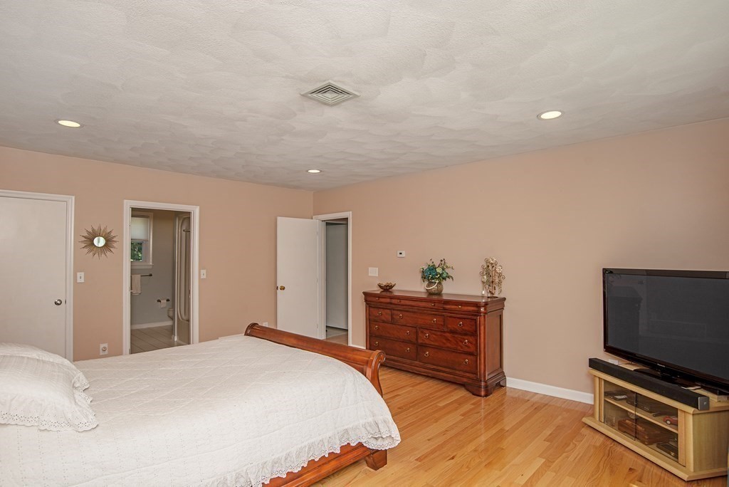 2 Mattakesett Circle Sharon, MA 02067 - Photo 17 of 40 a bedroom with a bed and a flat screen tv