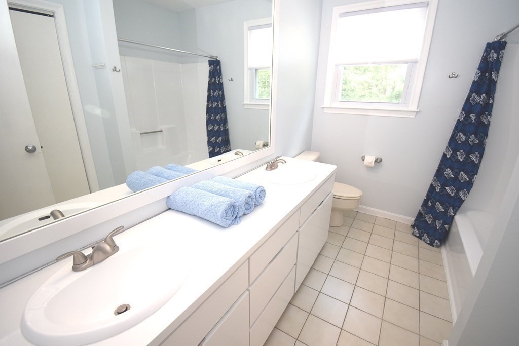 2 Mattakesett Circle Sharon, MA 02067 - Photo 33 of 40 a spacious bathroom with a sink a mirror and a shower