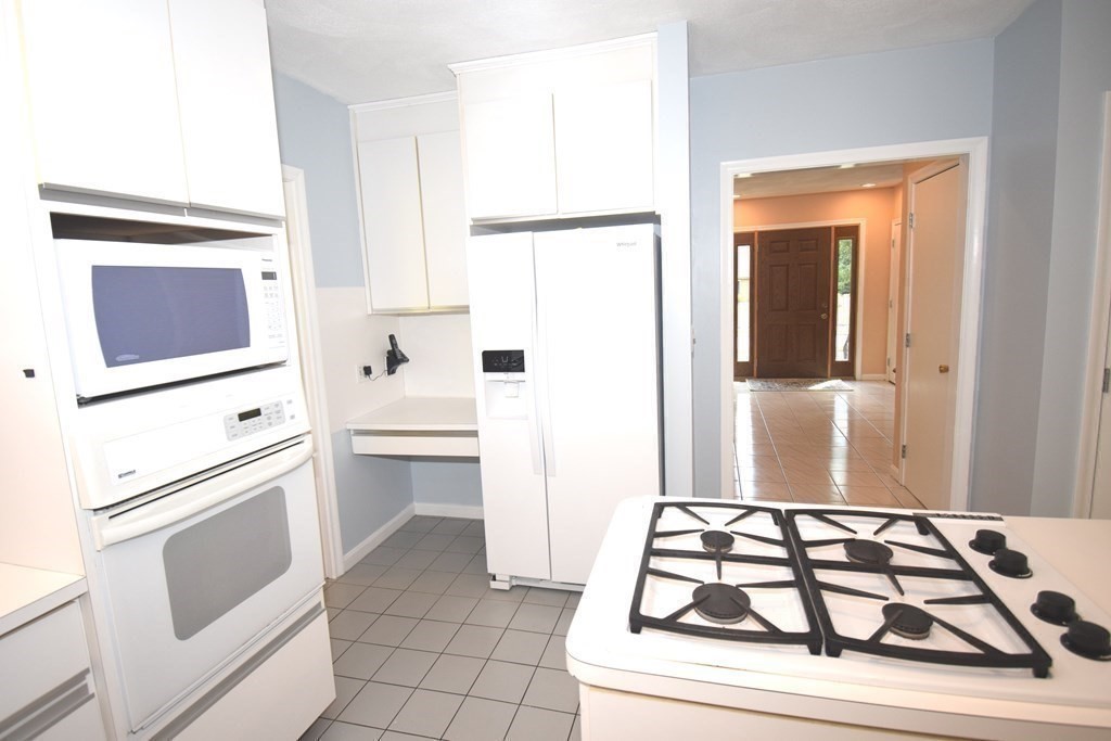 2 Mattakesett Circle Sharon, MA 02067 - Photo 7 of 40 a kitchen with white cabinets and white appliances