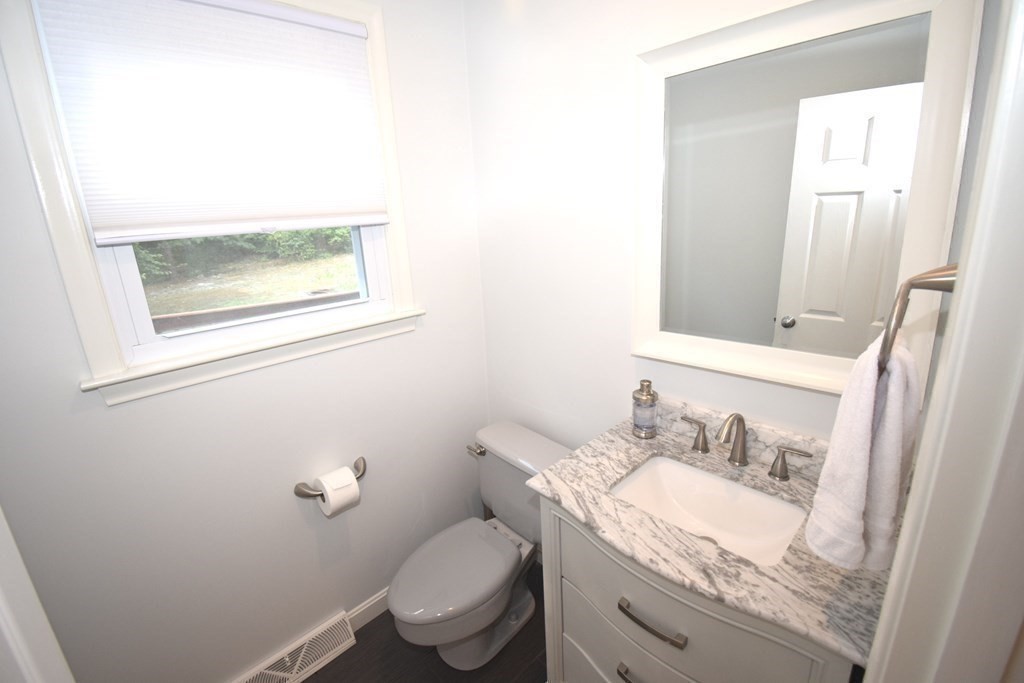 2 Mattakesett Circle Sharon, MA 02067 - Photo 9 of 40 a bathroom with a granite countertop sink a toilet and a mirror