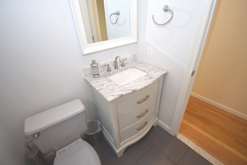 2 Mattakesett Circle Sharon, MA 02067 - Photo 10 of 40 a bathroom with a granite countertop toilet sink and mirror