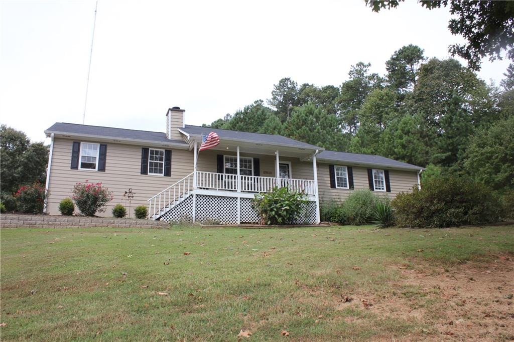 4120 Bullock Bridge Road Loganville, GA 30052 - Photo 1 of 1 a front view of house with yard and green space