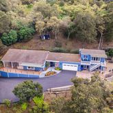 an aerial view of a house with swimming pool and garden view