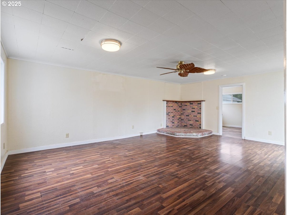 246 Jacobson Road Cathlamet, WA 98612 - Photo 11 of 33 a view of an empty room with wooden floor and a window