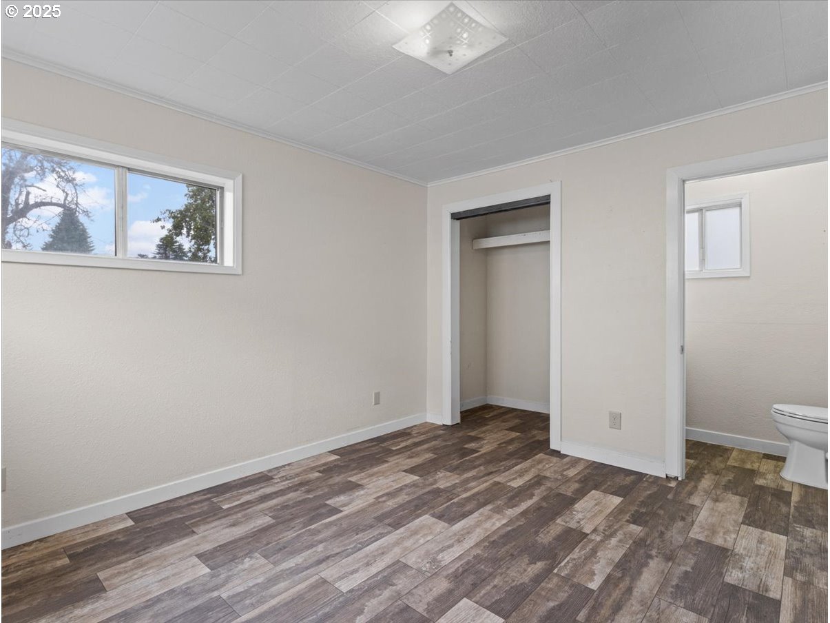 246 Jacobson Road Cathlamet, WA 98612 - Photo 13 of 33 a view of a bedroom with wooden floor and bathroom