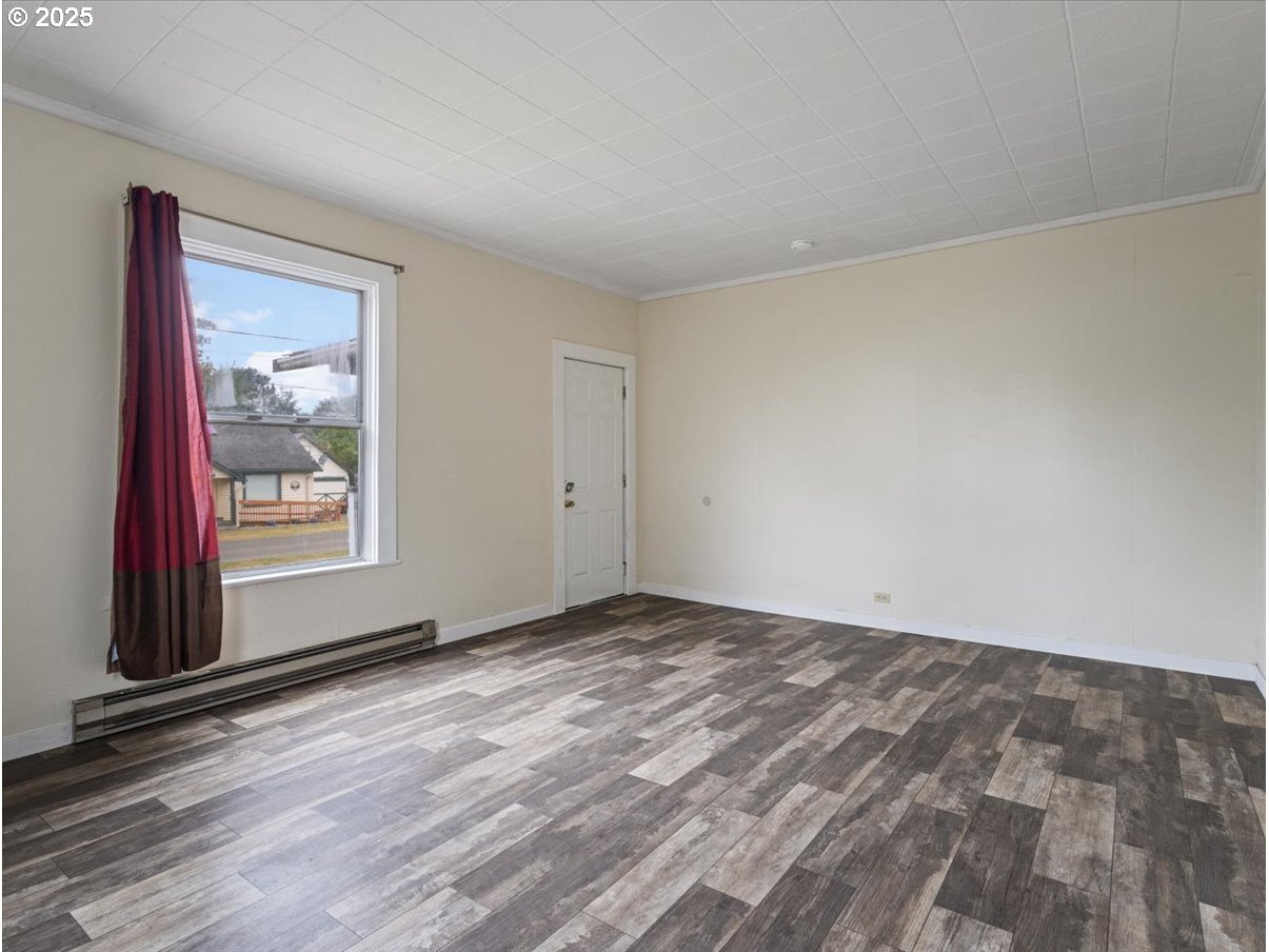 246 Jacobson Road Cathlamet, WA 98612 - Photo 16 of 33 a view of an empty room with window and wooden floor