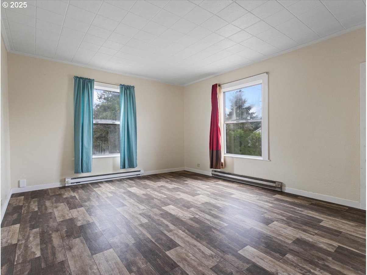 246 Jacobson Road Cathlamet, WA 98612 - Photo 17 of 33 a view of an empty room with wooden floor and a window