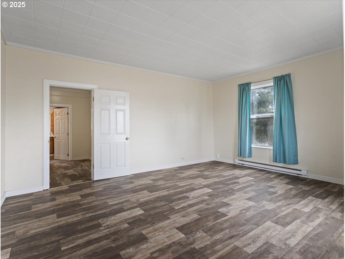 246 Jacobson Road Cathlamet, WA 98612 - Photo 18 of 33 a view of an empty room with wooden floor and a window