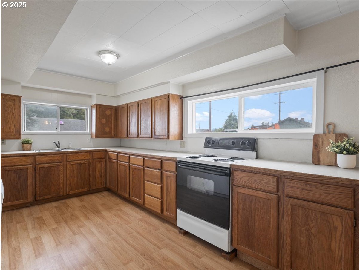 246 Jacobson Road Cathlamet, WA 98612 - Photo 7 of 33 a kitchen with stainless steel appliances granite countertop a stove a sink and white cabinets