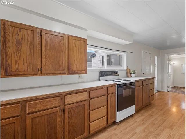 a view of a room with wooden floor