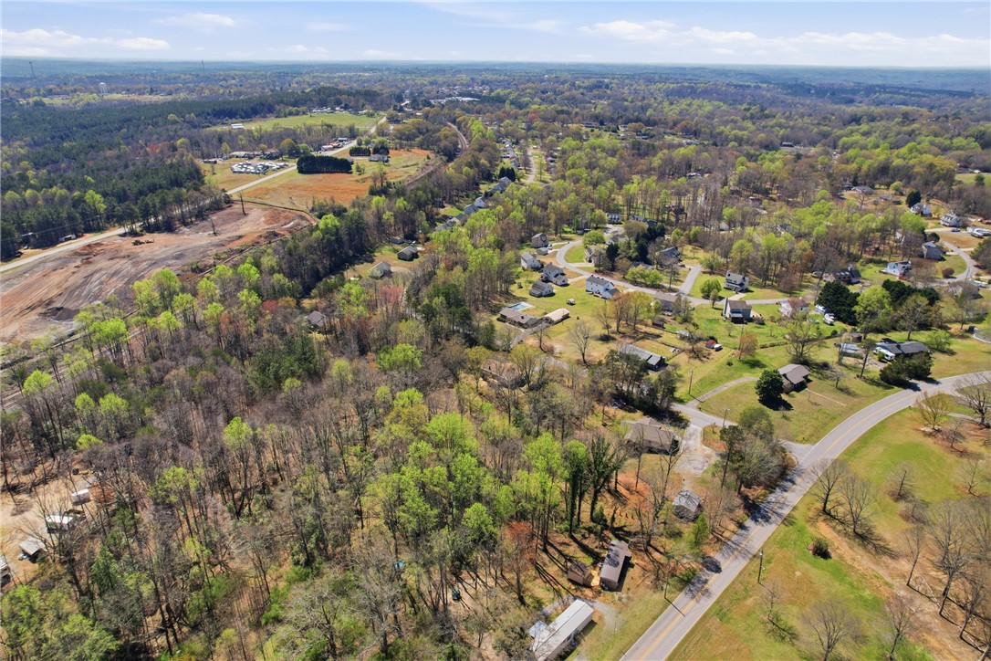 0 Springdale Avenue Liberty, SC 29657 - Photo 6 of 12 An aerial perspective reveals a vibrant, verdant landscape with homes nestled among flourishing trees.