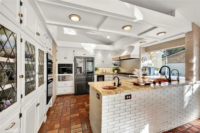 a view of a dining room with furniture a chandelier and wooden floor