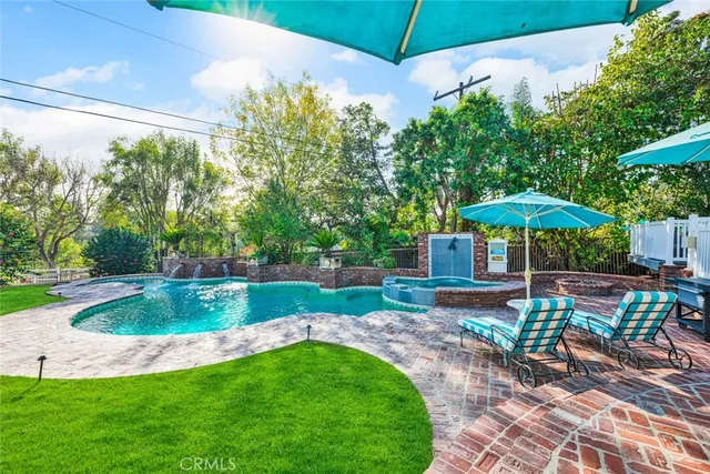 a living room with furniture a flat screen tv and a large window
