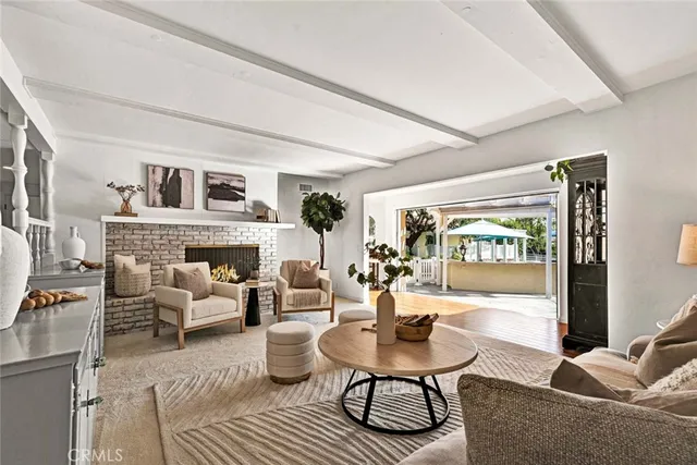 a living room with fireplace furniture and a large window