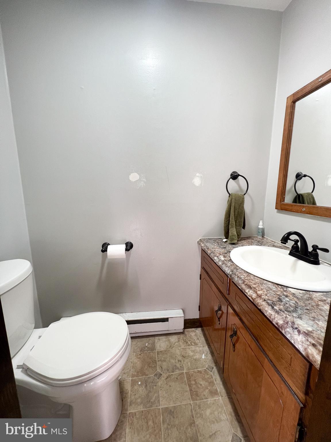 34 Cayuga Road Belleville, PA 17004 - Photo 16 of 46 a bathroom with a granite countertop toilet a sink and a mirror