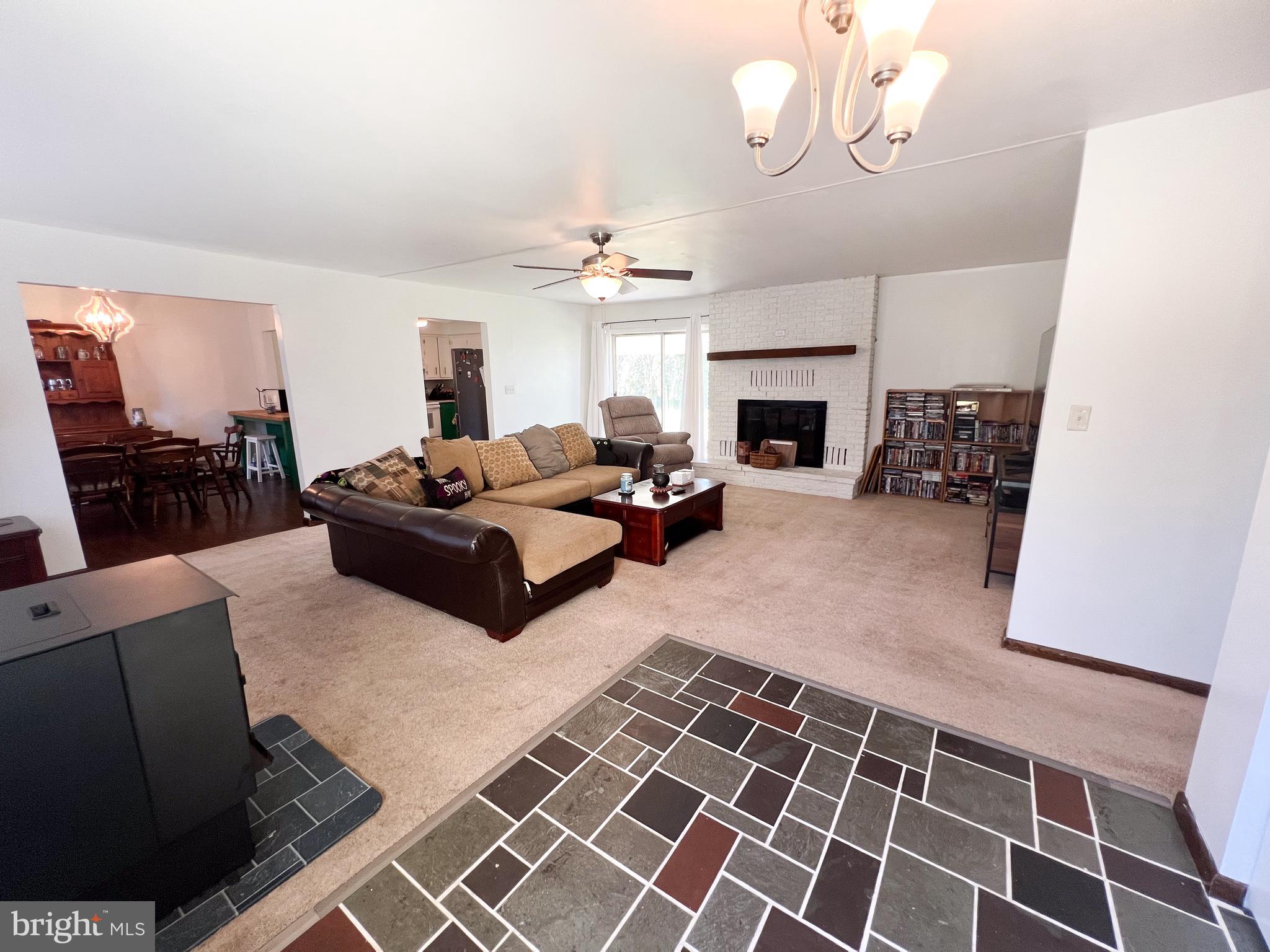 34 Cayuga Road Belleville, PA 17004 - Photo 5 of 46 a living room with furniture a fireplace and a chandelier