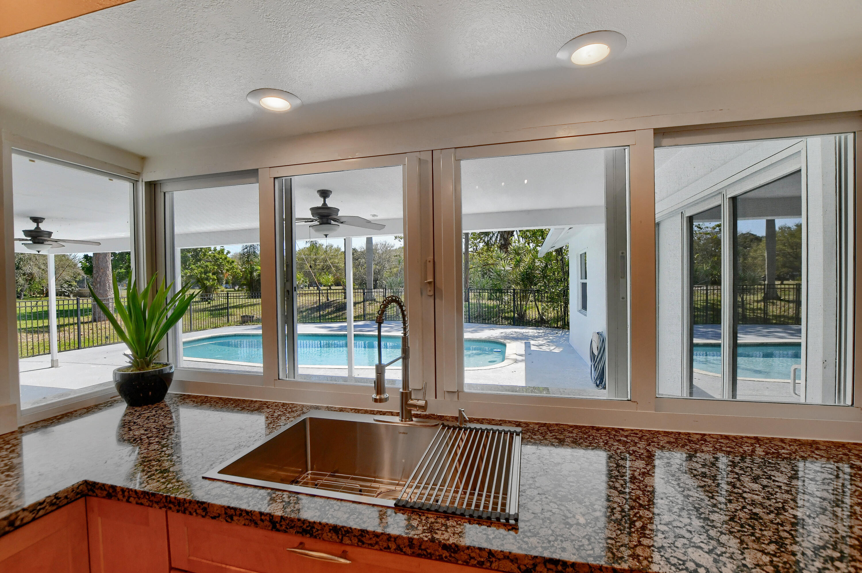 2334 Timbercreek Circle Northwest Boca Raton, FL 33431 - Photo 9 of 53 Kitchen with a pool view