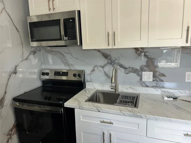 a kitchen with a stove and a microwave