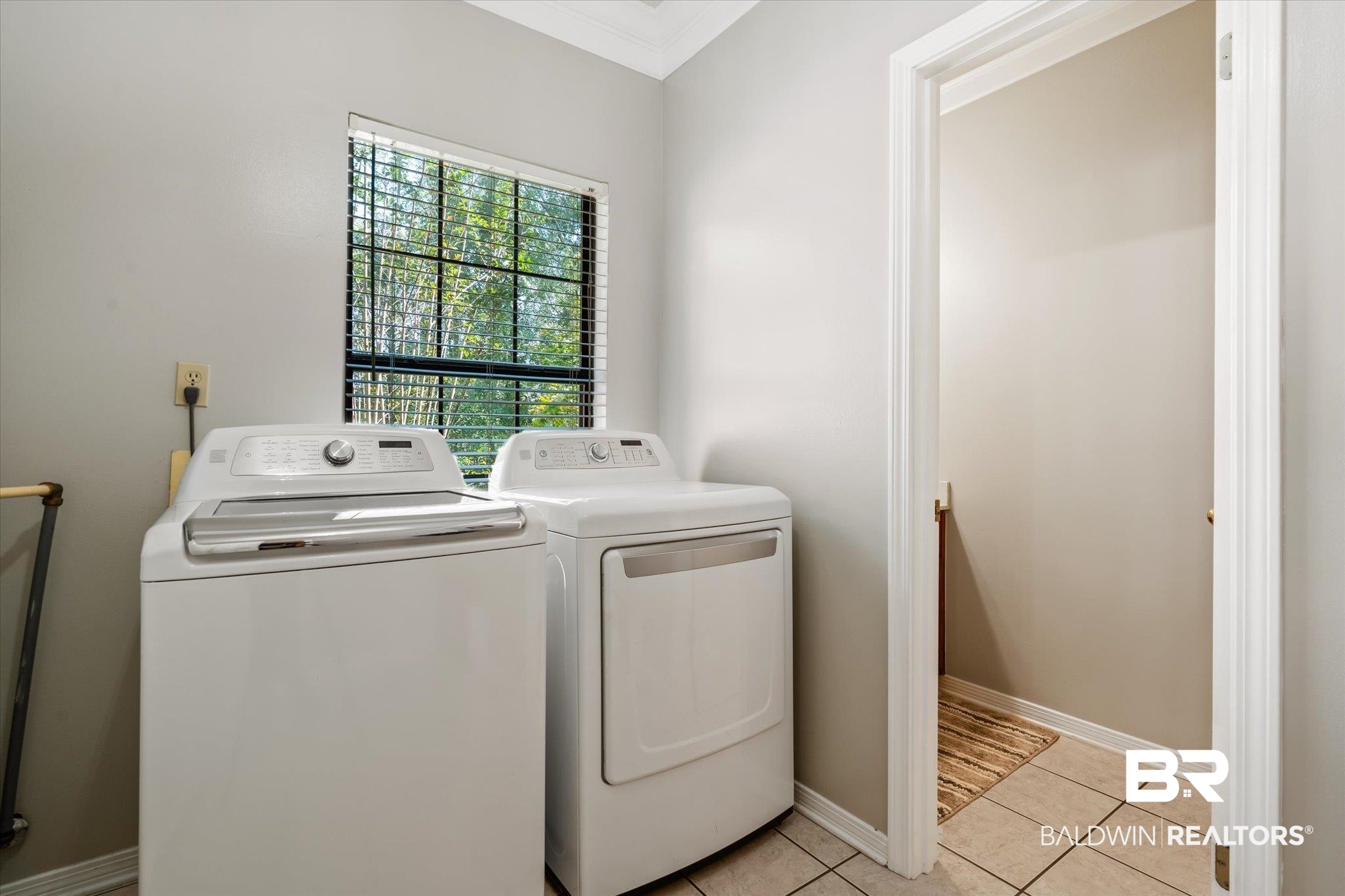 7360 Bridgewood Court Mobile, AL 36695 - Photo 23 of 30 Clothes washing area featuring light tile patterned flooring, washer and dryer, and ornamental molding