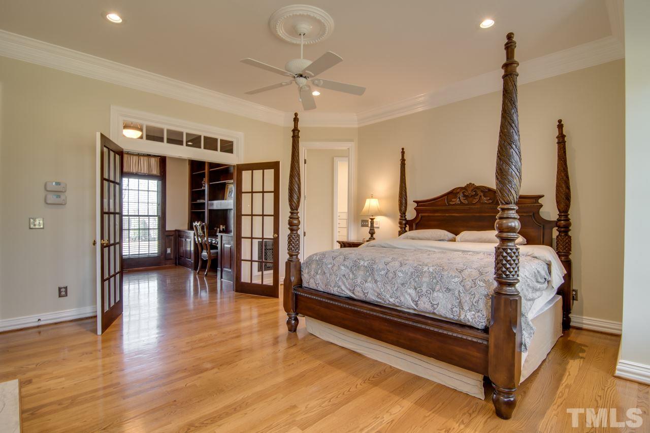 824 Rivers Edge Drive Graham, NC 27253 - Photo 15 of 30 a bedroom with a large bed and a chandelier