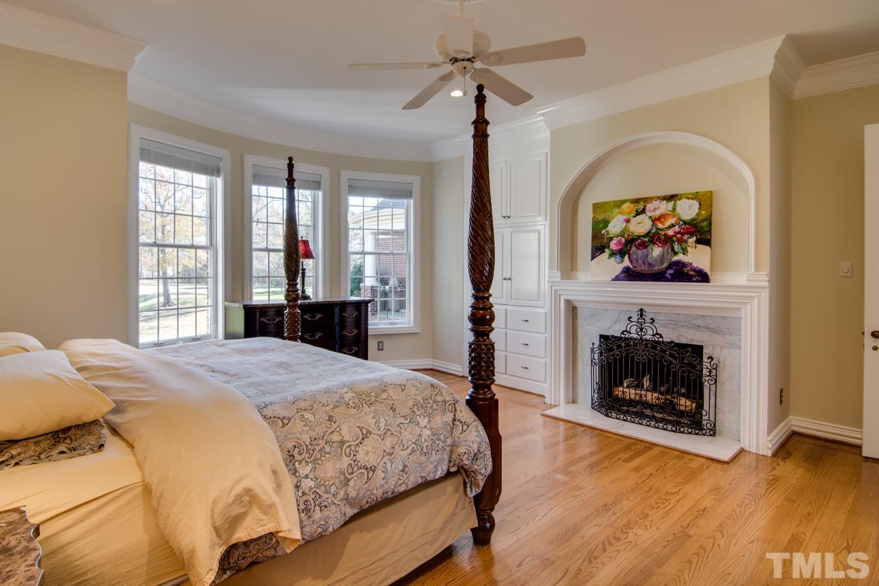 824 Rivers Edge Drive Graham, NC 27253 - Photo 16 of 30 a bedroom with a bed and a fireplace