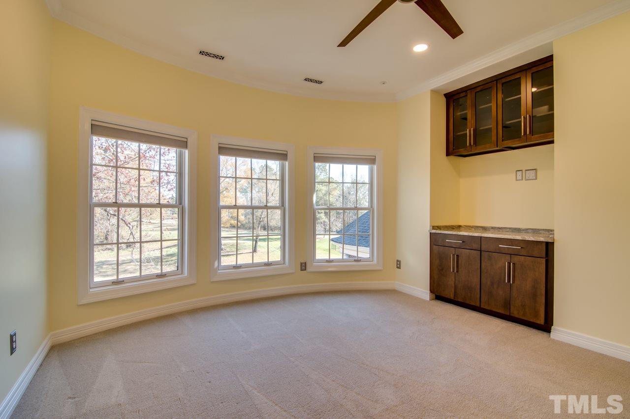 824 Rivers Edge Drive Graham, NC 27253 - Photo 23 of 30 a view of an empty room with a window and a kitchen