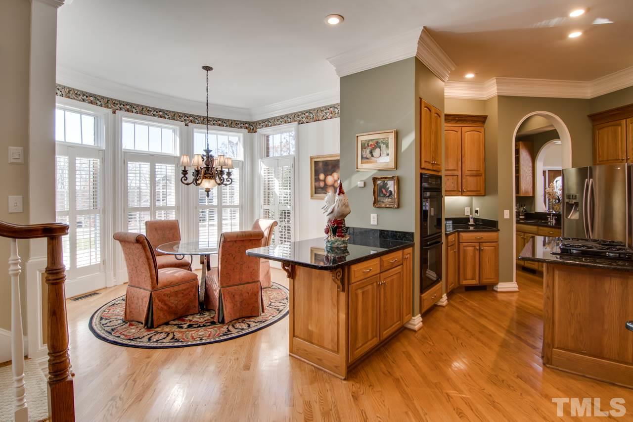 824 Rivers Edge Drive Graham, NC 27253 - Photo 9 of 30 a kitchen with stainless steel appliances granite countertop a stove and refrigerator