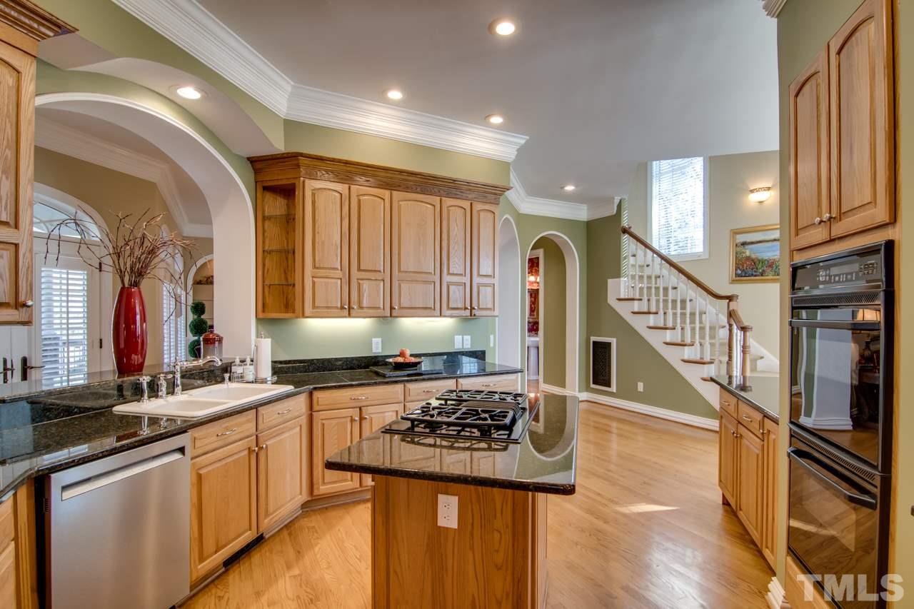 824 Rivers Edge Drive Graham, NC 27253 - Photo 10 of 30 a kitchen with lots of counter top space and wooden floor