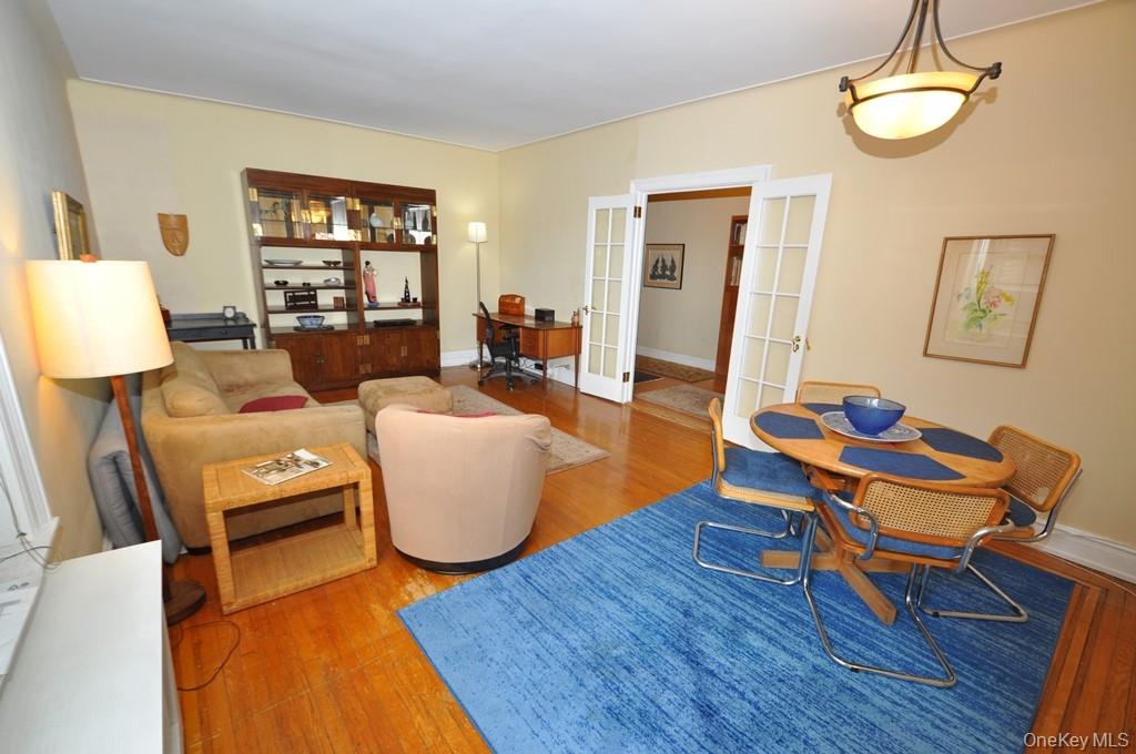 143 Garth Road, Unit 5J Scarsdale, NY 10583 - Photo 18 of 47 a living room with furniture wooden floor and a table