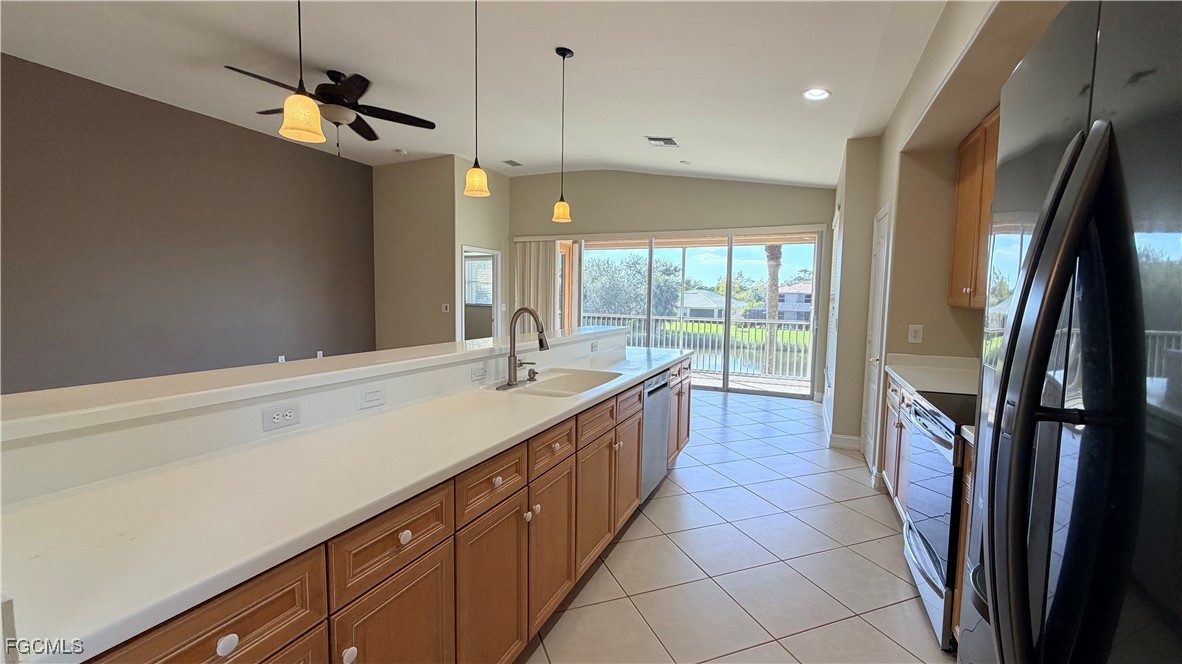 13071 Sandy Key Bend, Unit 304 North Fort Myers, FL 33903 - Photo 11 of 37 a large kitchen with a large window and stainless steel appliances