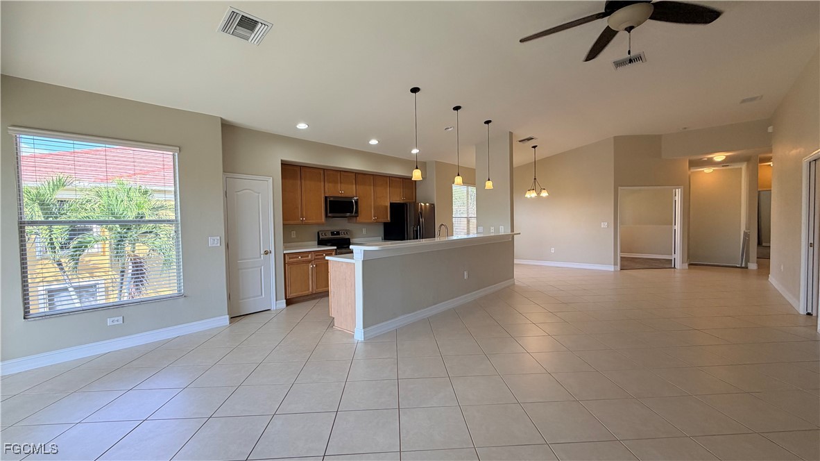 13071 Sandy Key Bend, Unit 304 North Fort Myers, FL 33903 - Photo 14 of 37 a view of a kitchen with kitchen island stainless steel appliances wooden floor and window